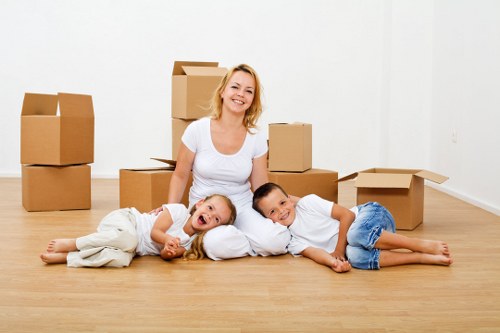 Movers carrying furniture through a residential property in Ruislip