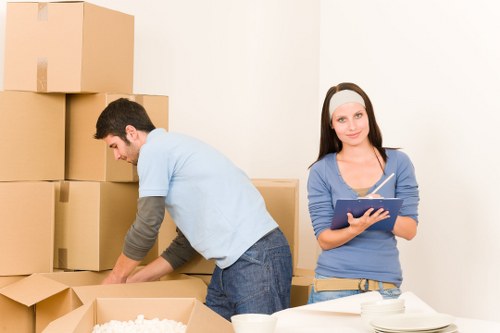 Movers handling furniture and access challenges in a Ruislip property