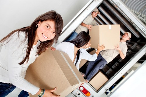 Careful loading of household furniture into a removals vehicle